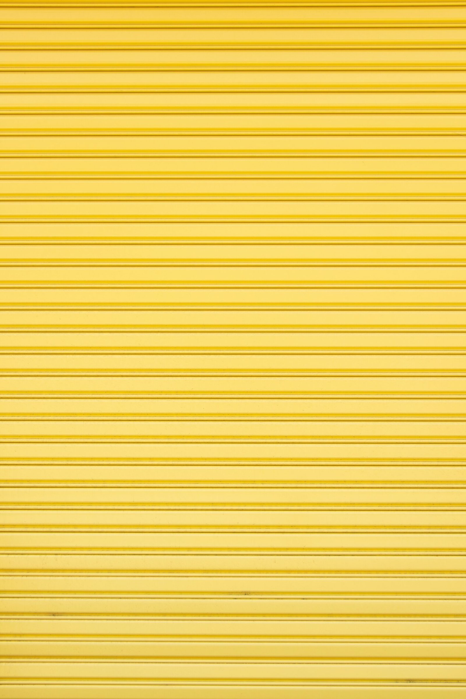 a yellow garage door that is closed